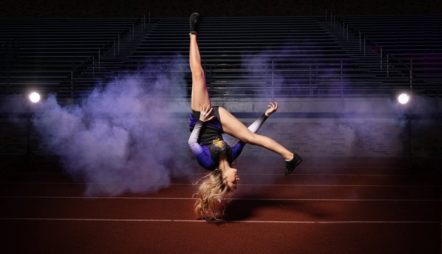 Senior gymnast portrait mid-flip
